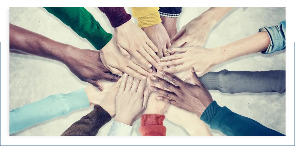 A group of people with their hands in the middle